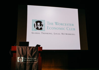 Worcester Economic Club logo being projected behind the speaker's podium.